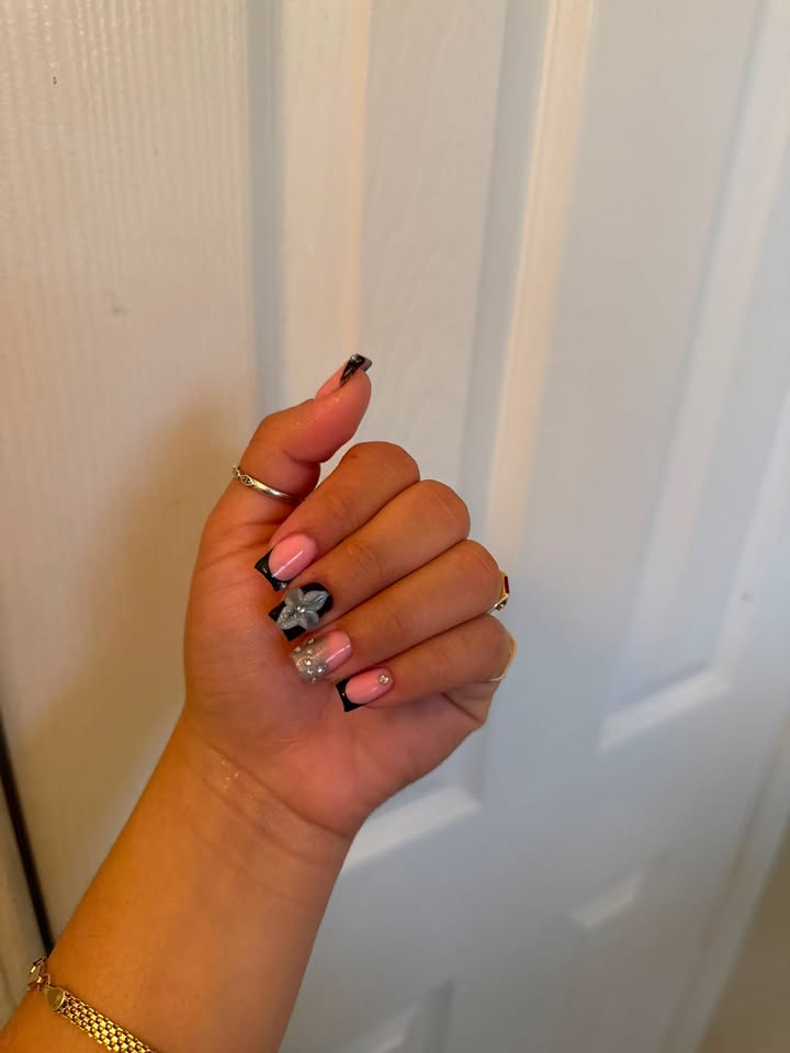 Black French manicure with silver bow nail art